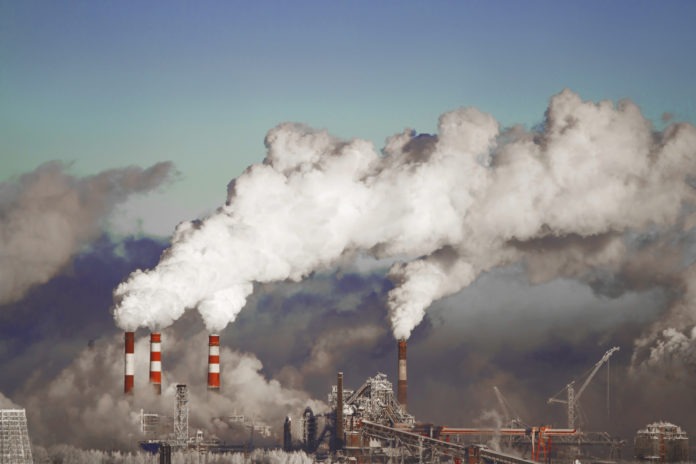 Poor environment in the city. Environmental disaster. Harmful emissions into the environment. Smoke and smog. Pollution of the atmosphere by plants. Exhaust gases.