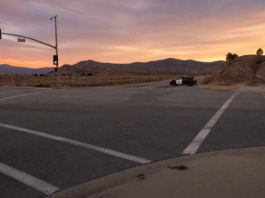 San Jacinto woman held in crash that killed 8-year-old Empty intersection at dusk with a patrol vehicle in the distance