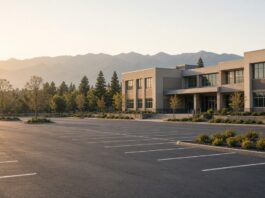 Illustration of an empty school campus parking lot at morning light, no people